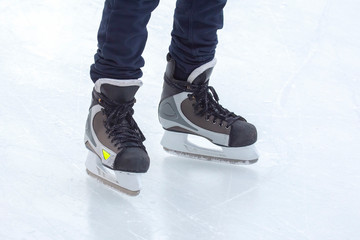 Naklejka premium Legs of a man skating on an ice rink. Hobbies and sports. Vacations and winter activities