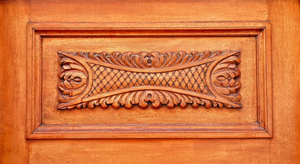 A decorative relief wooden carved panel.