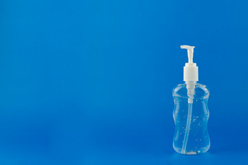 Coronavirus hand sanitizer crisis on a blue background with copy space