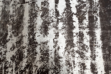 Metallic texture with scratches and cracks and stripes. The image includes an effect of black and white tones. Grunge background.