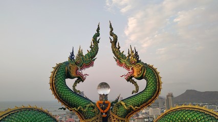 CHONBURI - THAILAND - February 29 , 2020 : Dragon statue in the temple on the mountain and views of the city of Sriracha.