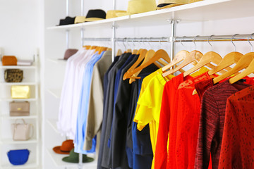 Fototapeta premium Stylish clothes on hangers in modern store
