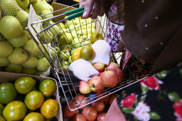 Close up of women hand shopping frutis 
