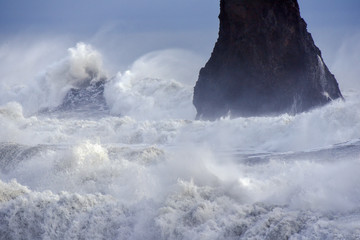 Powerful waves of the North Atlantic Ocean crash into the rocky shoreline of southern Iceland.