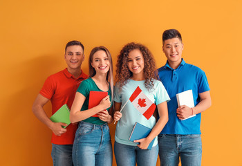 Young students of language school on color background