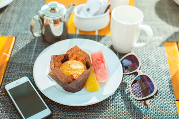 Breakfast,  Cup of cappuccino and a plate of croissants, muffins and fresh fruit