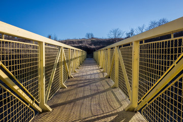 Small metal pedestrian bridge outside the city.