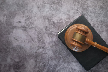 top view of wooden table and book on black background 