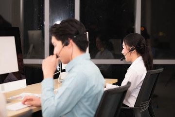 The male and female call center staff are determined to work after-sales service and provide...