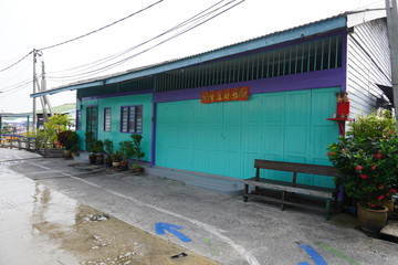 Typical front facade of traditional chinese wooden house with chinese poem and chinese new year decoration at Pulau Ketam.