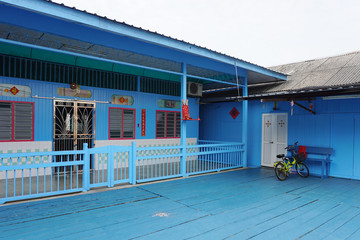 Typical front facade of traditional chinese wooden house with chinese poem and chinese new year decoration at Pulau Ketam.
