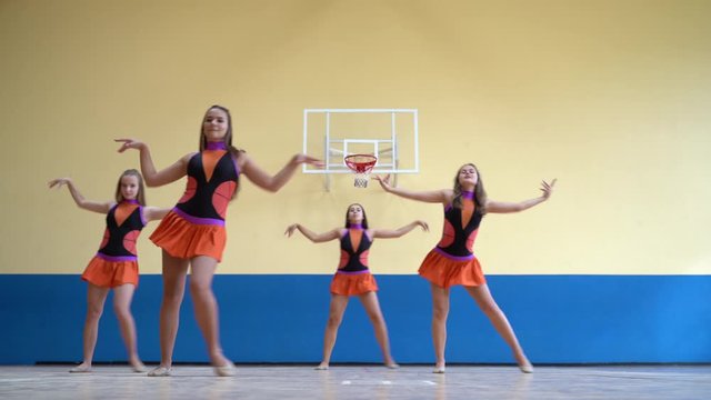 Cheer leaders tenage girls in uniform dancing and support university sport team