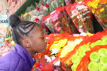 Kid smelling flower bouquets 
