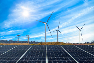 Photovoltaic modules solar power plant with wind turbines against and blue sky with...