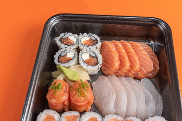Delicious and beautiful sushi on the orange table