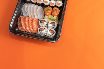 Delicious and beautiful sushi on the orange table