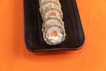Delicious and beautiful sushi on the orange table