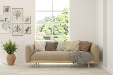 Minimalist living room in white color with sofa and summer landscape in window. Scandinavian interior design. 3D illustration