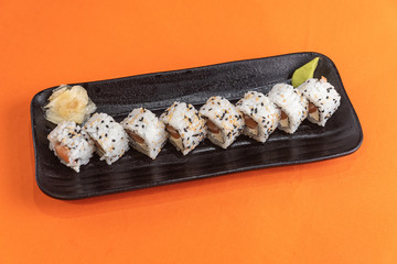 Delicious and beautiful sushi on the orange table