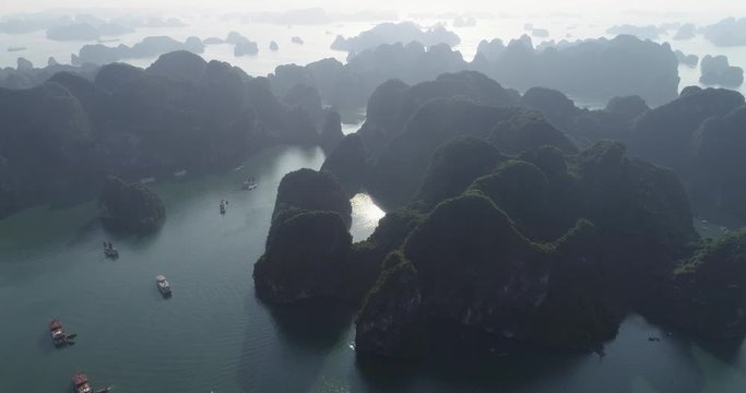 Aerial view of royalty high quality free stock footage over natural rocks green tops Halong bay, Titop island area and sea blue azure water. Wild natural untouched seascape. Asia Vietnam.