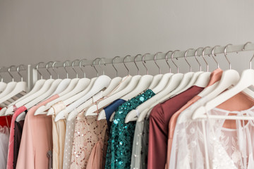 Colorful trendy collection of women's dresses hanging on a rack in a fashion boutique