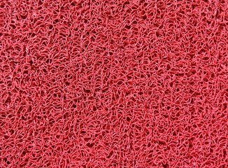 Red plastic doormat texture and background