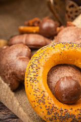 Bagels, chocolate gingerbread and chocolate on a background of coarse fabric. Close up.