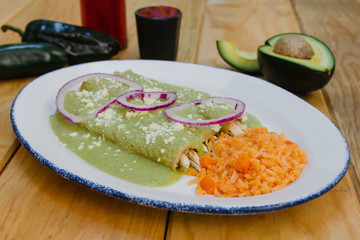 green enchiladas mexican food with tomato sauce and cheese in mexico