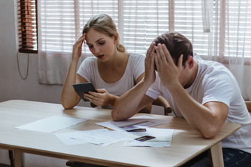 Stressed caucacian couple conflict of credit card bills or debt of over expense in shopping. Lover...