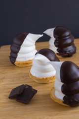 cupcakes in the shape of penguins of meringue with chocolate