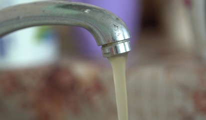 Dirty rusty brown water in plumbing. Environmental pollution. Water resources