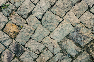 The gray wall of stones.