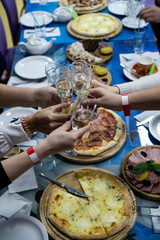 Pizza and food on the table with drinks. Holiday table setting.