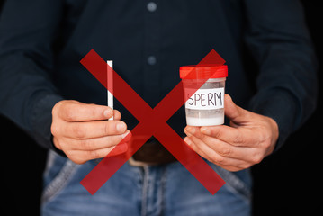 cigarette and a can of semen in the male hands of a donor