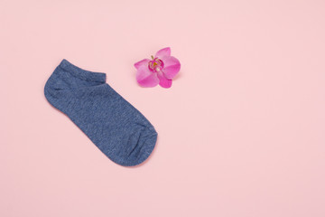 One woman sock on a pink background.