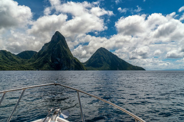 Gros and Petit Pitons near village Soufriere on Caribbean island St Lucia. Cruising towards the popular tourist attraction. World Heritage site. Relaxing on shore excursion boat tour from cruise ship. - obrazy, fototapety, plakaty