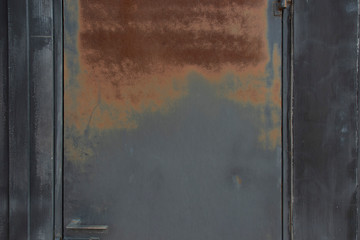 Rusty red on a black iron door.