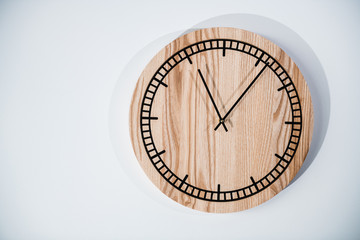 Round eco clock made of wood and epoxy. The subject of interior in your home. Natural handmade tree. Clock isolated on white background.