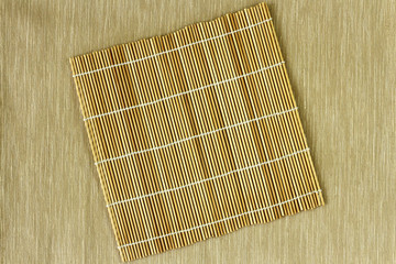 plate mat bamboo on top light brown cloth for background 