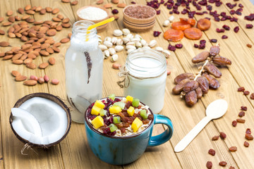 Muesli balanced protein breakfast. Fruits, berries  seeds, nuts, coconut. Coconut beverage and yogurt
