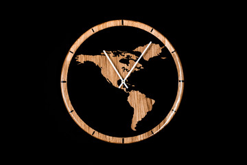 Round eco clock made of wood and epoxy. The subject of interior in your home. Natural handmade tree. Clock isolated on black background.