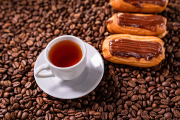 top view Cup tea, cake on background coffee beans