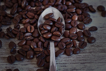 Metal teaspoon with coffee beans