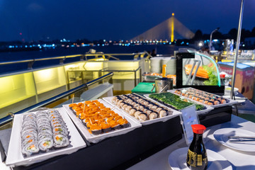 Sushi dinner buffet on a cruise ship near Rama VIII Bridge On the Chao Phraya River