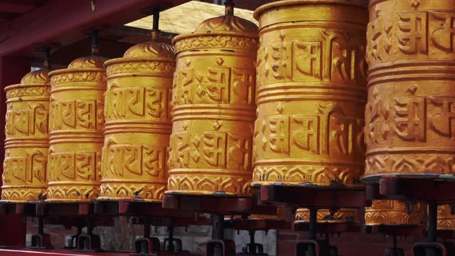 Buddhist Monastery with golden prayer wheels and golden Idol