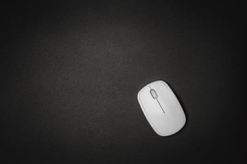 White computer mouse on black background, minimalism black.