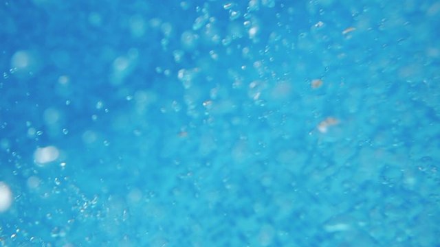 Bubbles rising to the surface. Air bubbles in water in swimming pool (underwater shot), good for backgrounds. Slow motion.