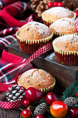 Christmas muffins covered powdered sugar on wooden table