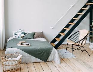 Scandinavian style bedroom design, light room, bed, stairs, chair, modern minimalist interior,...