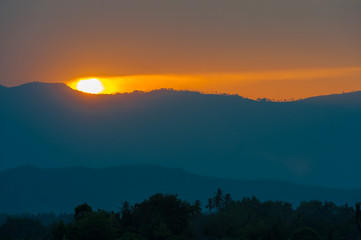 Golden light sunset behide the mountain in the evening